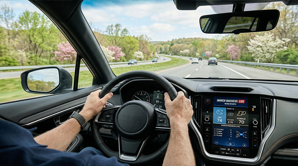 iPhone connected to car play bluetooth showing March Madness 2026 live scores on dashboard.