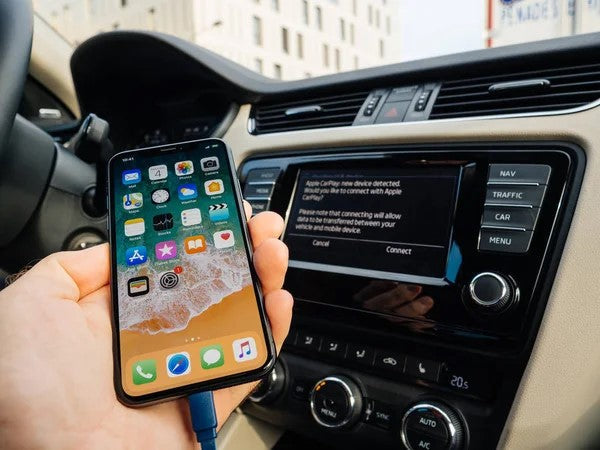 An Iphone and a car dashboard