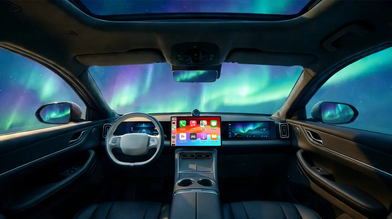 Wireless CarPlay adapter displaying navigation under the Aurora Borealis in a winter road trip.