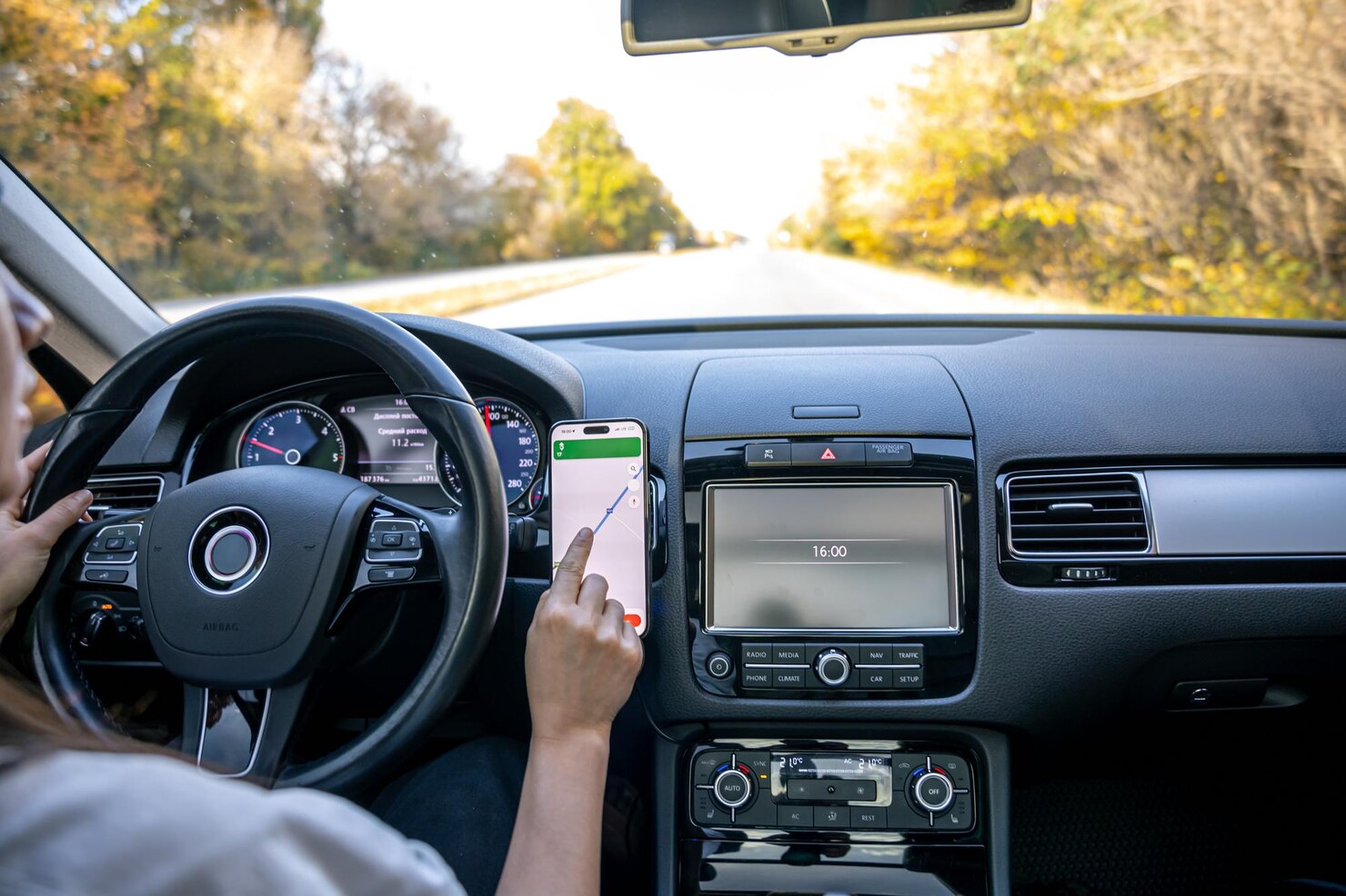 woman car holds mobile phone with gps navigation map
